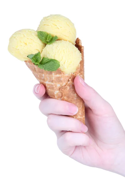 Hand holding yellow ice cream with mint in waffle cone isolated on white — Stock Photo, Image