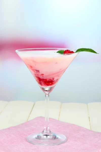 Raspberry milk dessert in cocktail glass, on light background — Stock Photo, Image