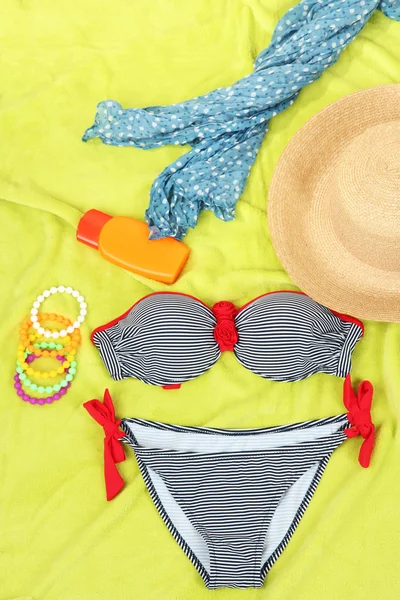 Swimsuit and beach items on bright background — Stock Photo, Image