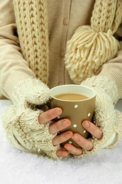 Female hands with hit drink, on light background — Stock Photo, Image