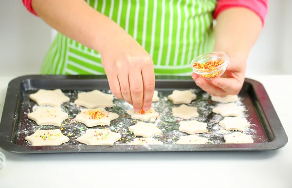 Woman in kitchen during cooking Christmas biscuits, close up — Stock Photo, Image