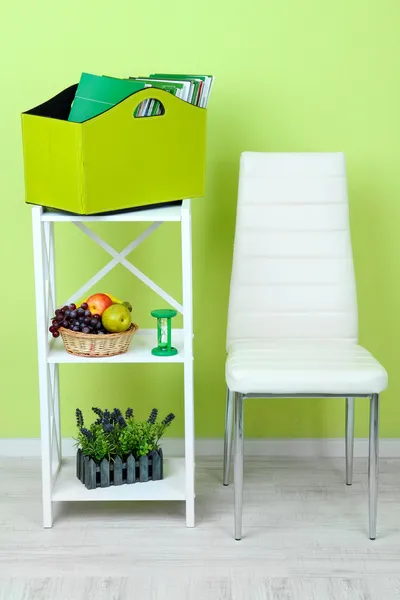 Tijdschriften en mappen in groene vak op plank in de kamer — Stockfoto