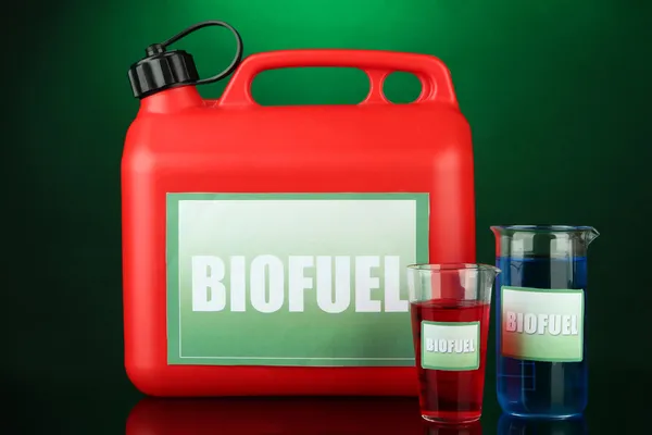 Bio fuels in canister and vials on green background — Stock Photo, Image