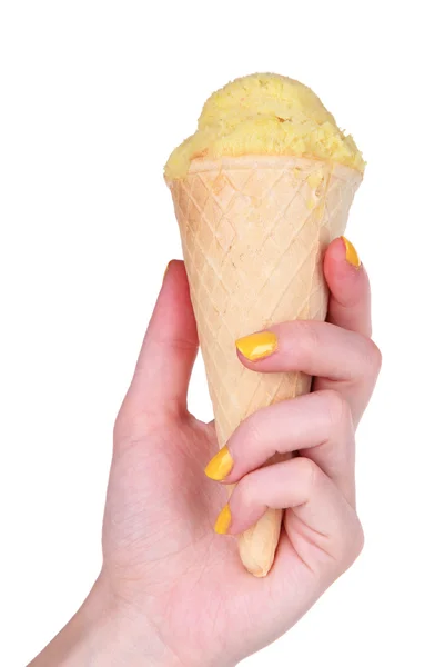 Hand holding yellow ice cream in waffle cone isolated on white — Stock Photo, Image