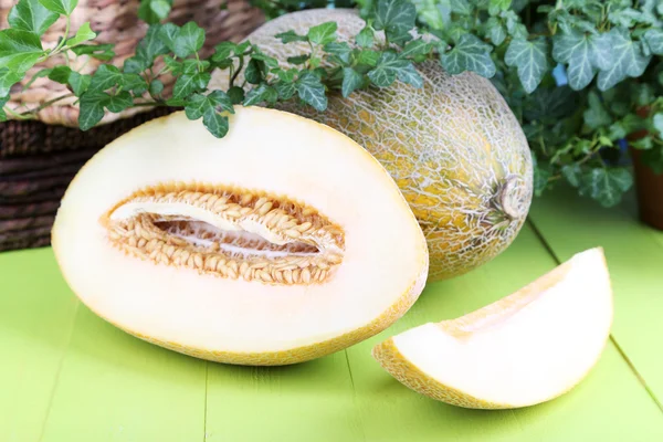 Ripe melons on wooden table on natural background — Stock Photo, Image