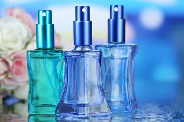 Women perfume in beautiful bottles and flowers — Stock Photo, Image