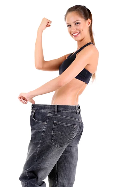 Slim girl in big jeans isolated on white — Stock Photo, Image