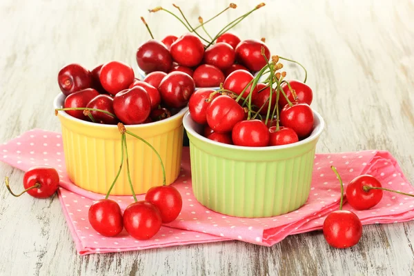 Kirschbeeren in Schalen auf Holztisch in Großaufnahme — Stockfoto