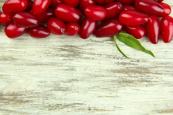 Fresh cornel berries on wooden background — Stock Photo, Image