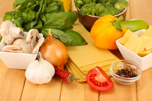 Vegetarian lasagna ingredients on wooden background — Stock Photo, Image