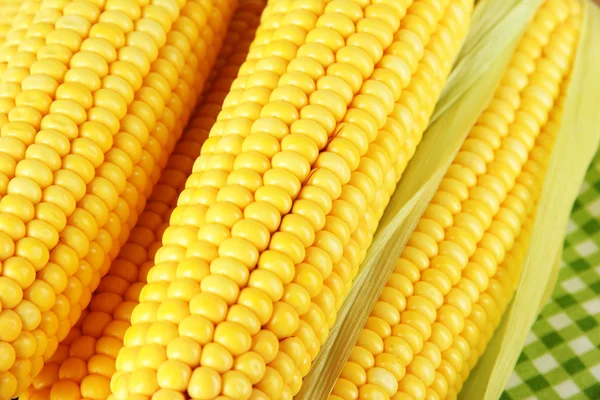 Crude corns on napkin on wooden table — Stock Photo, Image