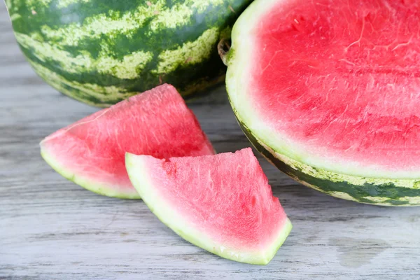 Ripe watermelons on wooden table — Stock Photo, Image