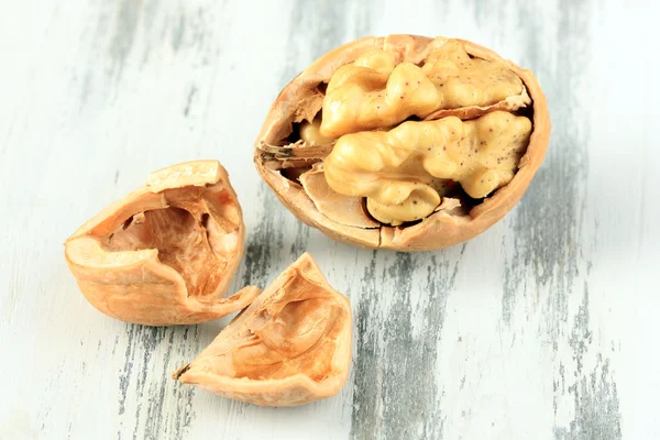 Broken walnut on wooden table close-up — Stock Photo, Image