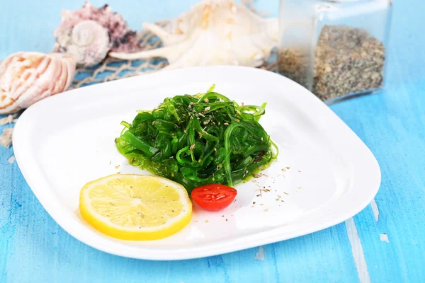 Sea kale on plate on wooden table close-up — Stock Photo, Image