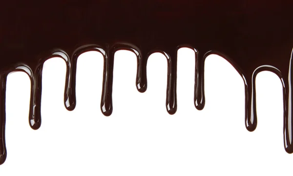 Melted chocolate dripping on white background — Stock Photo, Image