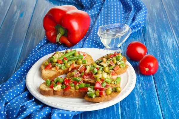 Sandwiches con verduras y verduras en plato sobre mesa de madera de cerca — Foto de Stock