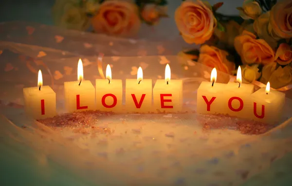 Candles with printed sign I LOVE YOU,on color fabric background — Stock Photo, Image