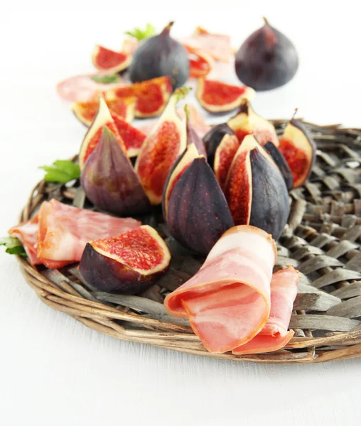 Figues savoureuses avec jambon sur table en bois blanc — Photo