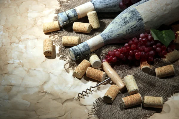 Alte Flaschen Wein, Trauben und Korken auf altem Papierhintergrund — Stockfoto