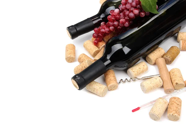 Bottles of wine, grapes and corks, isolated on white — Stock Photo, Image
