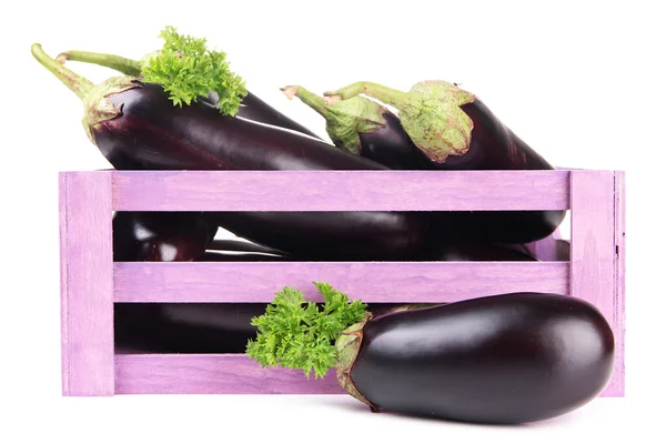 Fresh eggplants in wooden box isolated on white — Stock Photo, Image