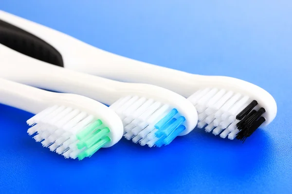 Tooth-brushes on blue background — Stock Photo, Image