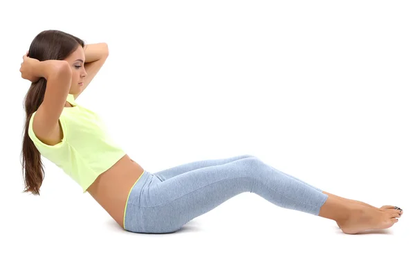 Young beautiful fitness girl doing yoga exercise isolated on white — Stock Photo, Image