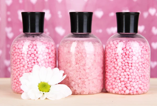 Aromatherapy minerals - colorful bath salt on pink background — Stock Photo, Image