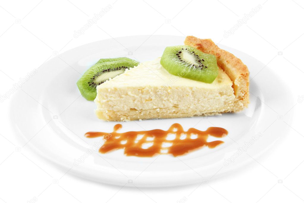 Slice of cheesecake with kiwi fruit and caramel sauce on plate