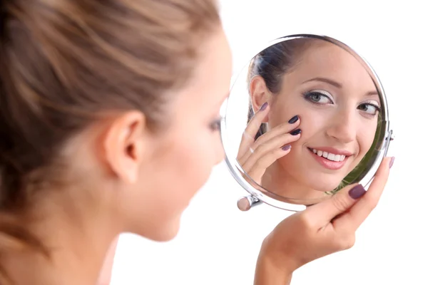 Beautiful girl preens before small mirror isolated on white — Stock Photo, Image