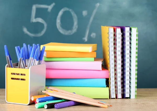 Office supplies on table on school board background — Stock Photo, Image