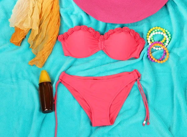 Swimsuit and beach items on bright blue background — Stock Photo, Image