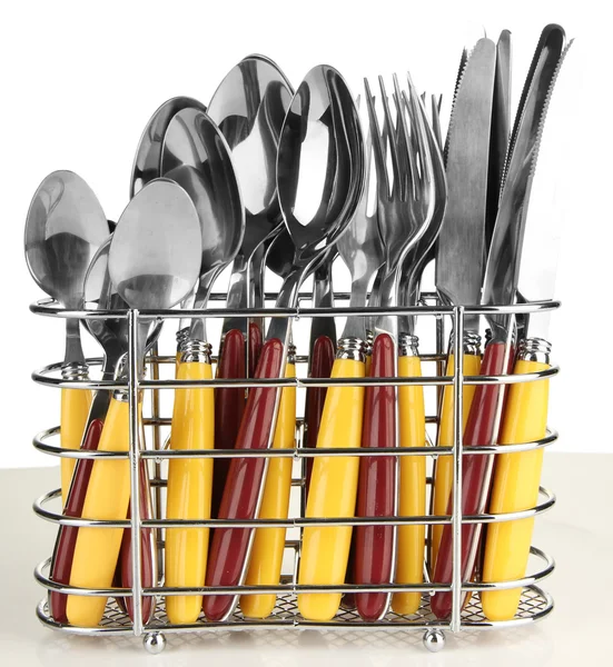 Knives, forks and spoons in metal stand isolated on white — Stock Photo, Image