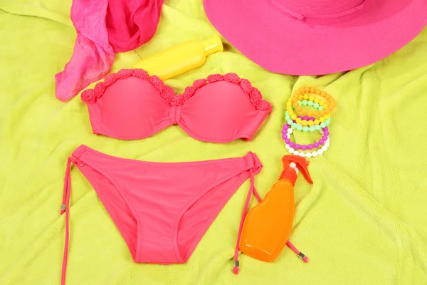 Swimsuit and beach items on bright background — Stock Photo, Image