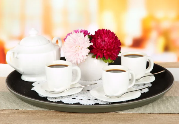 Cups of coffee on tray on table in cafe — Stock Photo, Image