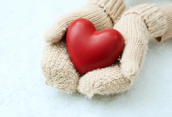 Female hands in mittens with red heart, close-up — Stock Photo, Image