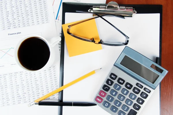 Office supplies with documents and cup of coffee close up — Stock Photo, Image