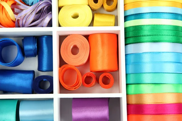 Bright silk ribbons in white wooden box, close up — Stock Photo, Image