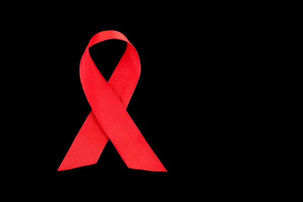 Red ribbon HIV, AIDS isolated on black