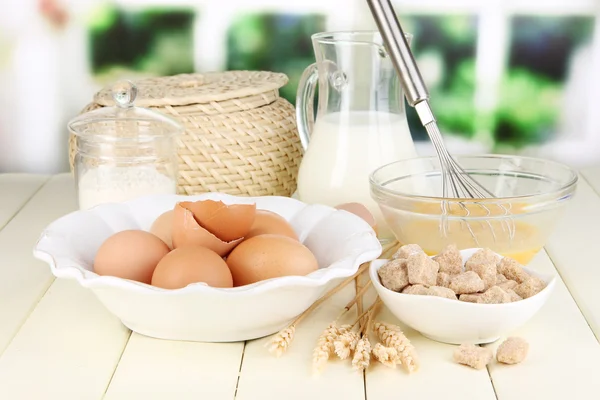 Ingredients for dough on wooden table on window background — Stock Photo, Image