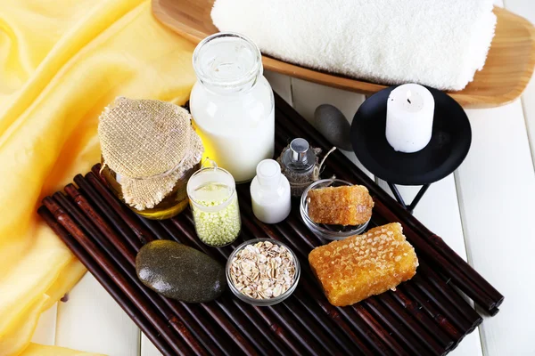 Honey and milk spa with oils and honey on wooden table close-up — Stock Photo, Image