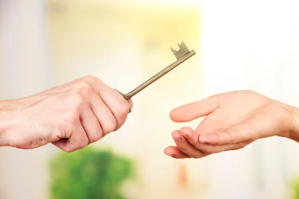 Transfer of house key, on bright background — Stock Photo, Image