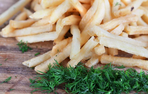 French fries on wooden board close-up — Stock Photo, Image