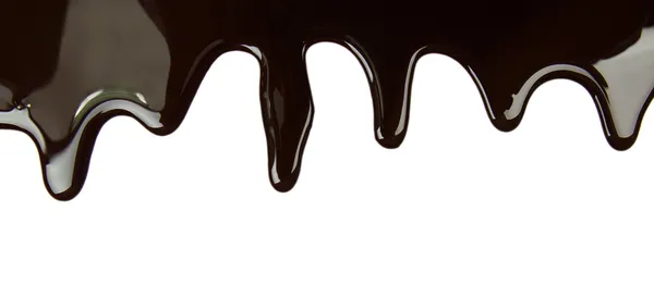 Melted chocolate dripping on white background — Stock Photo, Image