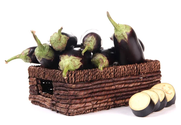 Fresh eggplants in wicker basket isolated on white — Stock Photo, Image