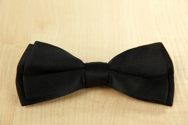 Black bow tie on wooden background — Stock Photo, Image