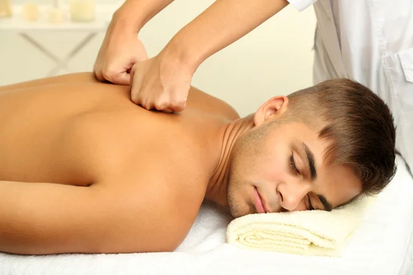 Young man having back massage close up — Stock Photo, Image