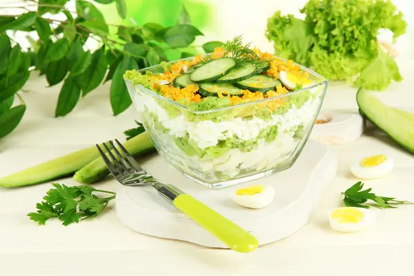 Delicious salad with eggs, cabbage and cucumbers on wooden table — Stock Photo, Image
