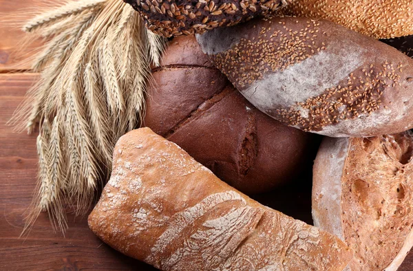 Much bread on wooden board — Stock Photo, Image