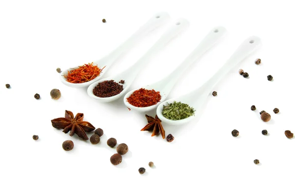 Assortment of spices in white spoons, isolated on white — Stock Photo, Image